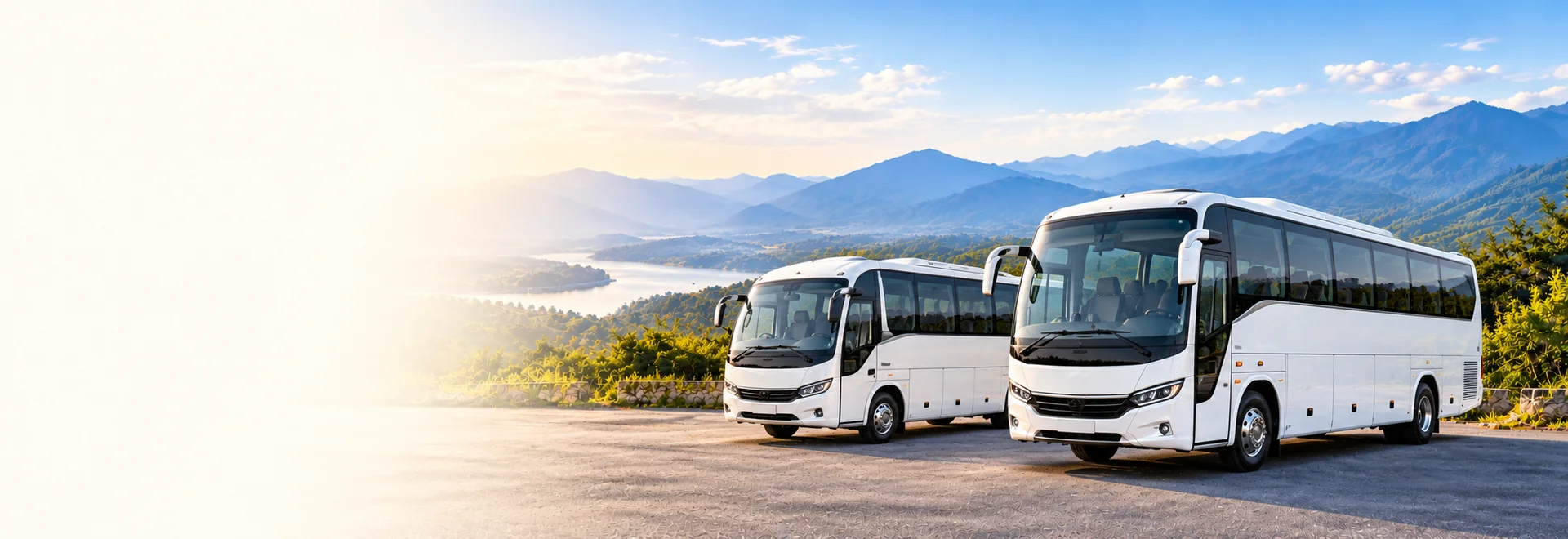 White mini bus and tourist coach beside a scenic road